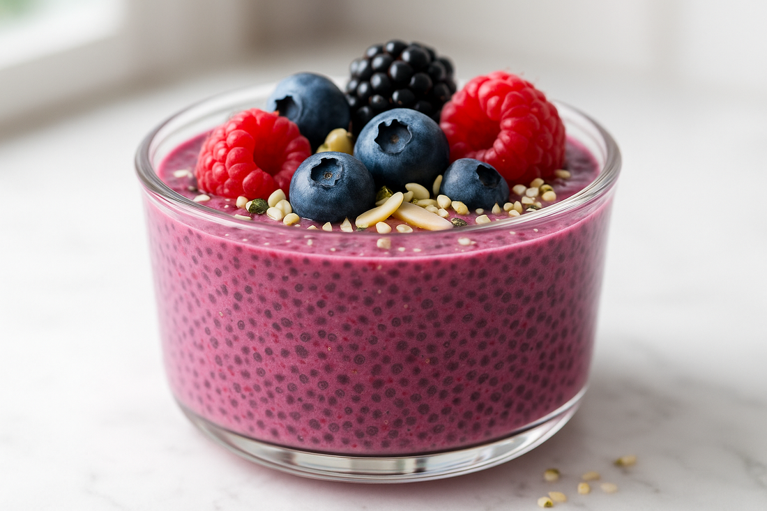 A glass jar filled with purple-pink berry chia pudding topped with fresh mixed berries, sliced almonds, and hemp seeds, photographed with bright natural lighting on a clean surface